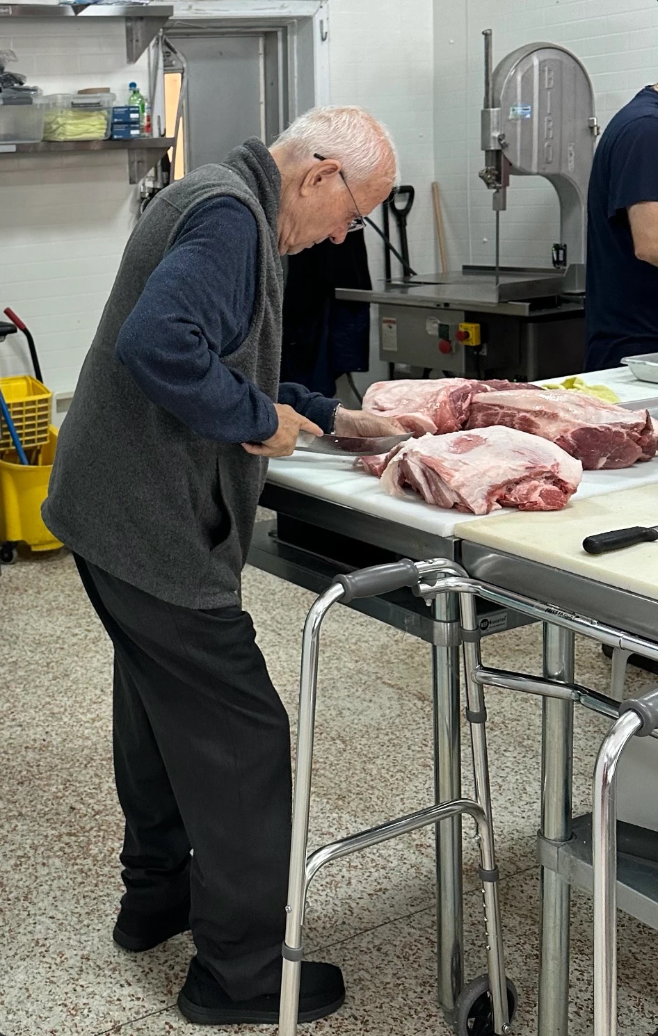 Our butcher cutting fresh pork at the block